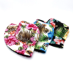 Detailed view of floral sun hats featuring tropical hibiscus and palm leaf prints