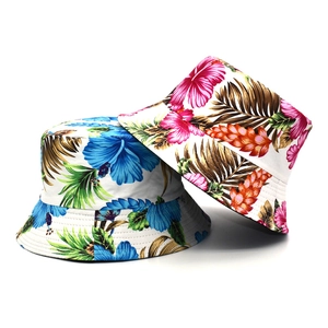 Detail of tropical floral sun hats in pink and blue featuring hibiscus leaf prints