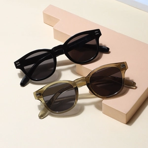 Retro square frame sunglasses in black and translucent tea colors with rivet detail