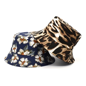 Detail of reversible bucket hats in navy floral print and classic leopard pattern