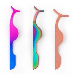 Three metal eyelash tweezers in gradient pink, rainbow, and rose gold finishes