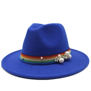 Close-up of dark blue wool fedora featuring colorful rainbow band and pearl embellishments