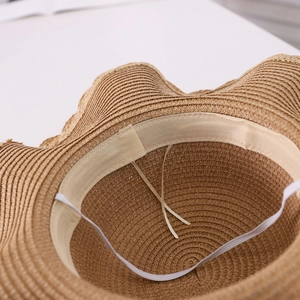 Detail shot of the internal sweatband and adjustable string inside the straw sun hat