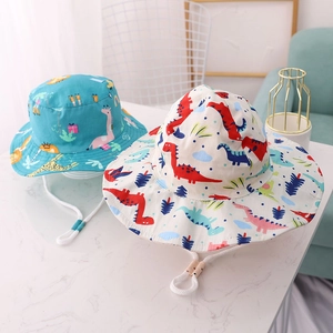 Detail of kids sun hats featuring cute dinosaur and giraffe prints with adjustable straps
