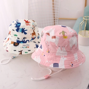 Detail of kids bucket hats featuring cartoon animal prints and adjustable windproof ropes