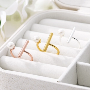 Detailed view of adjustable pearl open rings in gold, rose gold, and silver finishes