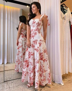 Detail of red floral print summer dress featuring bow-tie straps and tiered cake skirt
