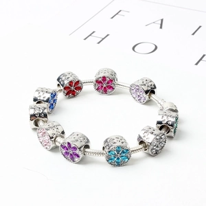 Silver snake chain bracelet with crystal-encrusted charms and colorful gemstones