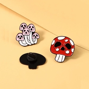 Three-piece set of skull mushroom enamel pins with pink and red designs and rubber back