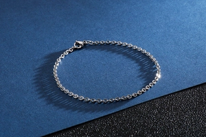 Detailed view of silver stainless steel cable chain bracelet with lobster clasp closure