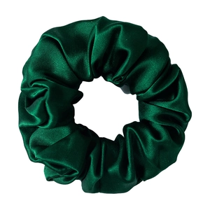 Detailed view of glossy dark green 100% mulberry silk scrunchie with a satin finish
