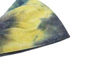 Detailed close-up of yellow and gray tie-dye knit yoga headband with marble texture
