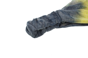 Close-up of tie-dye yoga headband showing elastic stitching and blue-yellow fabric texture