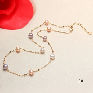 Detailed view of freshwater pearl necklace with multi-color beads and heart charm