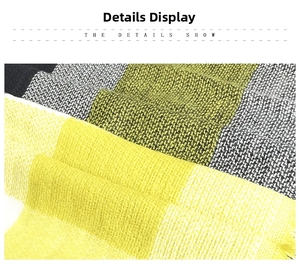 Detail shot of the yellow and grey plaid pattern and woven texture of the cashmere scarf