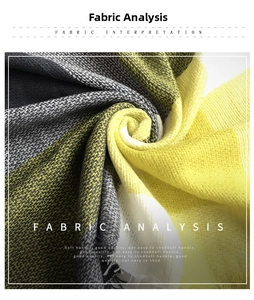 Detail of yellow and grey plaid cashmere-like scarf with soft texture and fringe edges
