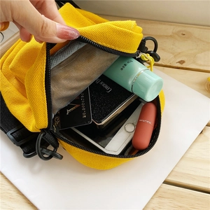 Yellow daisy canvas crossbody bag for women showing interior storage space and capacity