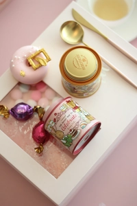 Close-up of bunny lulu tin box and gift packaging with gold lid and brand logo details