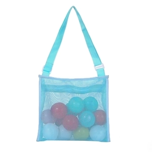 Detail view of light blue mesh beach bag with adjustable strap and colorful toys inside