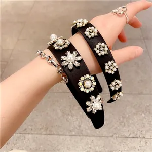 Wide black fabric headband with sparkling floral rhinestones and elegant pearls