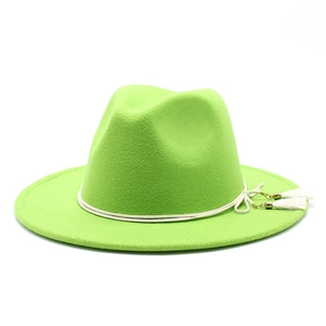 Detail of neon green wool fedora hat with white rope band and tassel fringe decoration