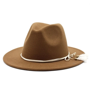 Detail of wool felt fedora featuring a white rope band and metallic tassel accents