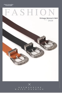 Close-up of three vintage leather belts with ornate engraved alloy buckles in 45-degree view