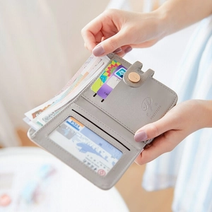 Women's light grey short wallet with multi-card slots and secure button closure