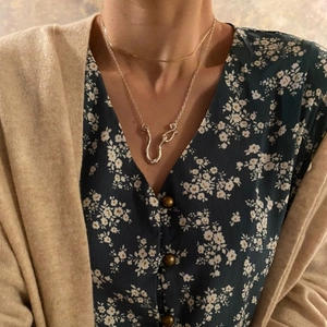 925 sterling silver layered necklace with abstract asymmetric U-shaped pendant on a model