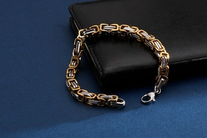 Close-up of gold and silver bicolored Byzantine chain bracelet with a lobster clasp