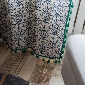 Classical beige shower curtain with blue floral prints and green tassel fringe trim