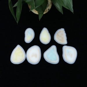 Top view of 7 assorted geometric silicone molds for DIY resin pendants on black background