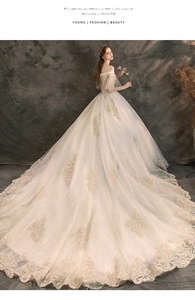Detailed embroidery and gold lace texture on an off-shoulder luxury wedding dress