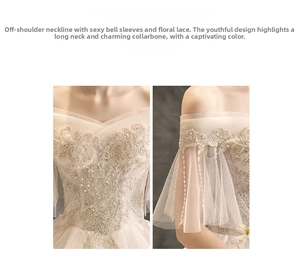 Detail of off-shoulder lace wedding dress with flared sleeves and floral embroidery