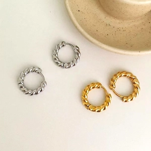 Classic gold and silver twisted hoop earrings with textured metal finish for women