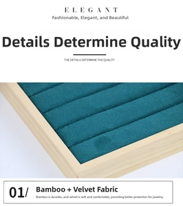 Detail view of premium bamboo wood jewelry display tray with green velvet ring slots