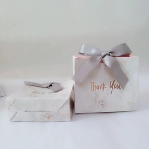 Elegant marble pattern paper gift box with golden Thank You text and grey silk ribbon bow
