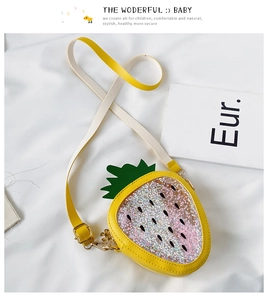 Detail of sequin strawberry crossbody bag with yellow leather trim and green leaf decor