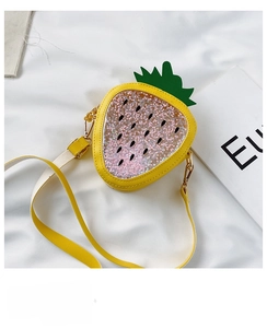 Detail of yellow strawberry crossbody bag with pink star sequins and adjustable strap
