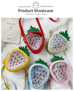 Flat lay of colorful strawberry cross-body bags with glitter sequins for girls