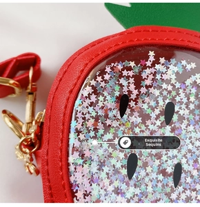 Macro shot of strawberry sequin bag showing sparkling star-shaped glitter and leather texture