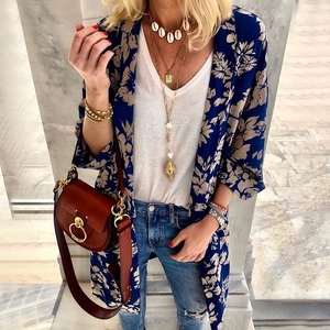 Women's casual blue floral print kimono cardigan styled with jeans and a leather bag