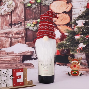 Christmas gnome wine bottle cover with red knit hat and white beard on festive background