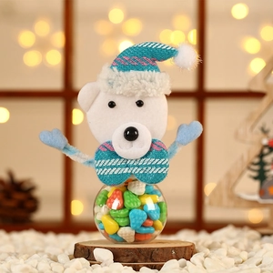 Macro view of Christmas bear candy jar with blue knit hat on round wooden base