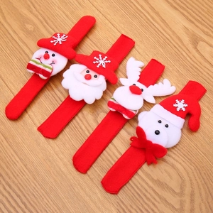 Luminous Christmas slap bracelets with Santa and snowman on light wood background