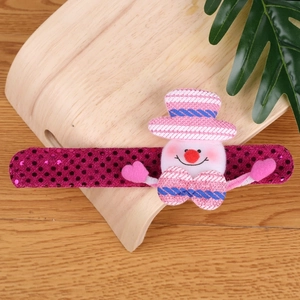 Pink and purple sequin Christmas snowman snap bracelet on a wooden display stand