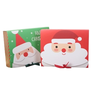 Red and green Christmas gift boxes with Santa Claus designs and ribbon ties