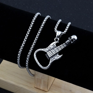 Detail of silver skull guitar pendant necklace on a black velvet display stand