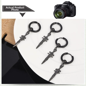 Detail of vintage punk black cross sword earrings for men with gothic dagger pendant