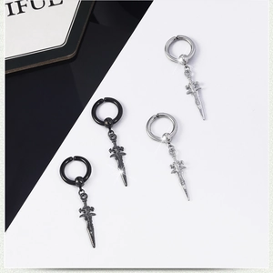 Detail view of vintage punk sword earrings in black and silver metal finishes